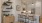 kitchen area with bar stools next to a drink mixing station